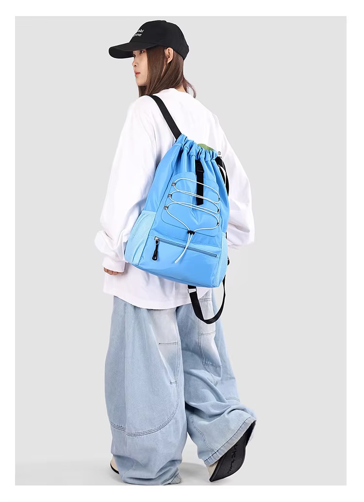 woman wearing sky blue backpack side view