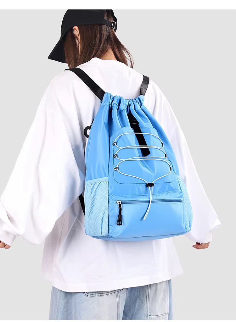 woman wearing sky blue backpack back view