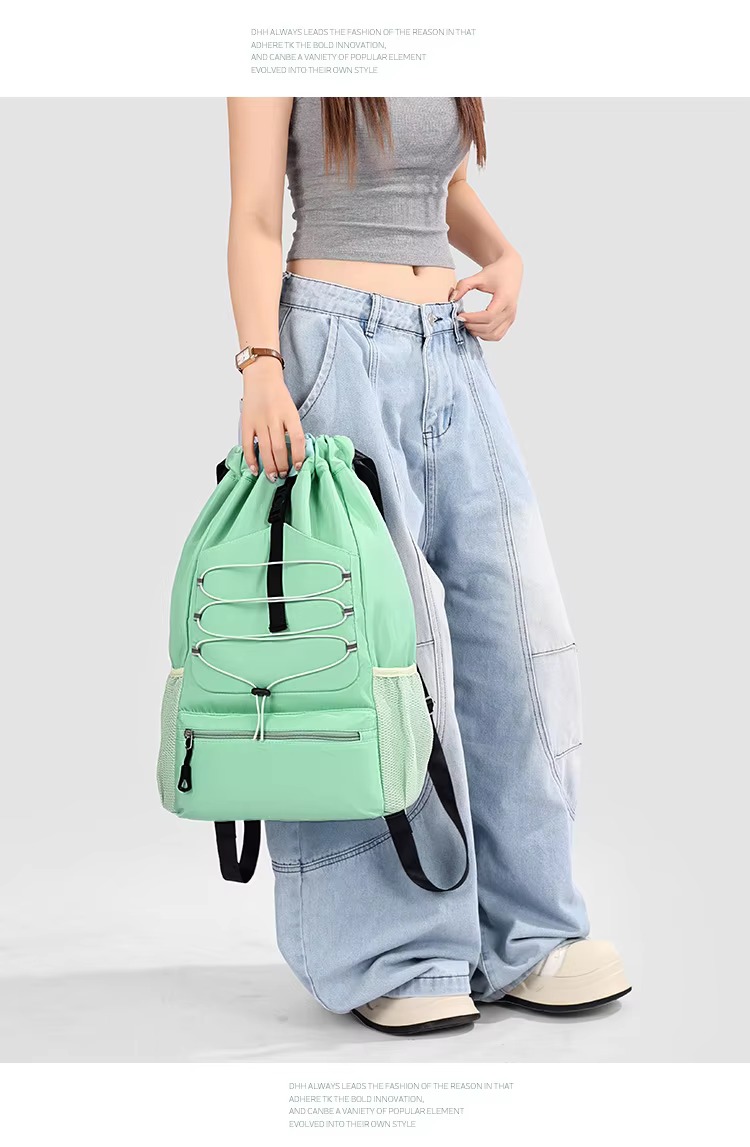 woman holding green backpack