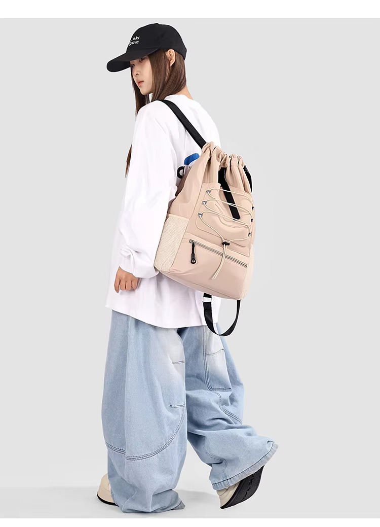 woman wearing khaki backpack