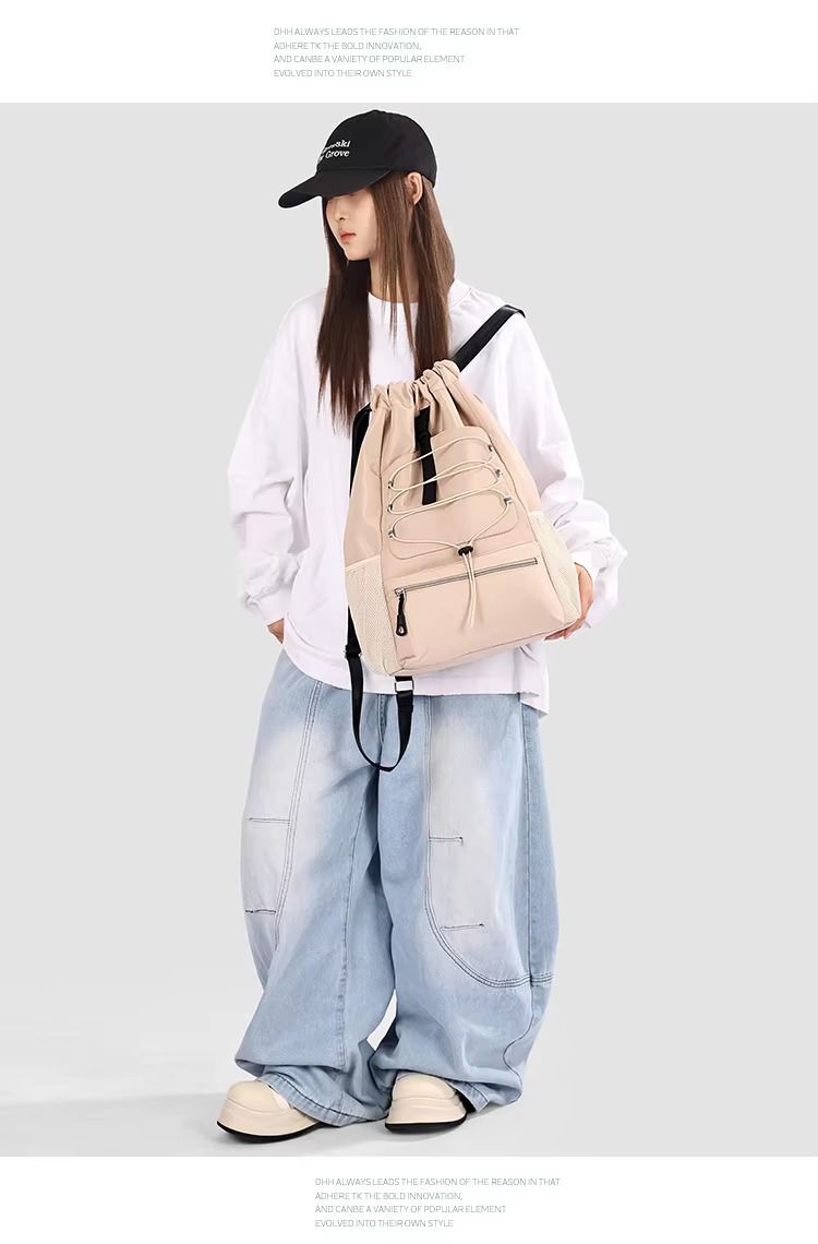 woman holding khaki backpack front