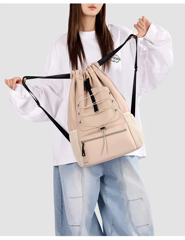 woman holding khaki backpack straps