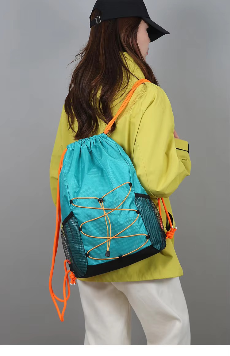 woman wearing lake green backpack