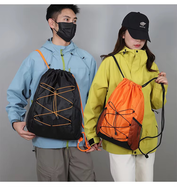couple with black and orange backpacks