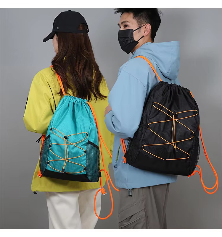 couple with lake green and black backpacks