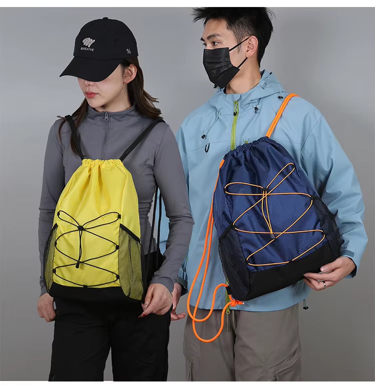 couple with yellow and navy backpacks