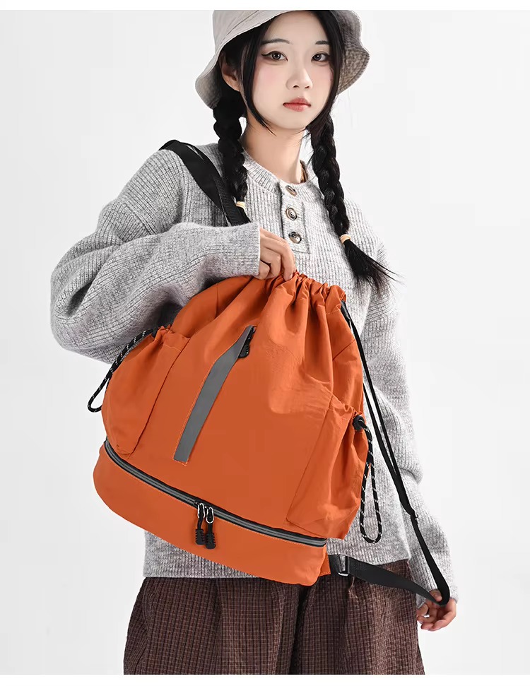 woman holding orange backpack
