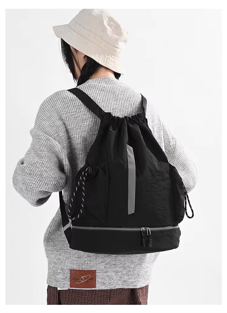 woman wearing black backpack back view