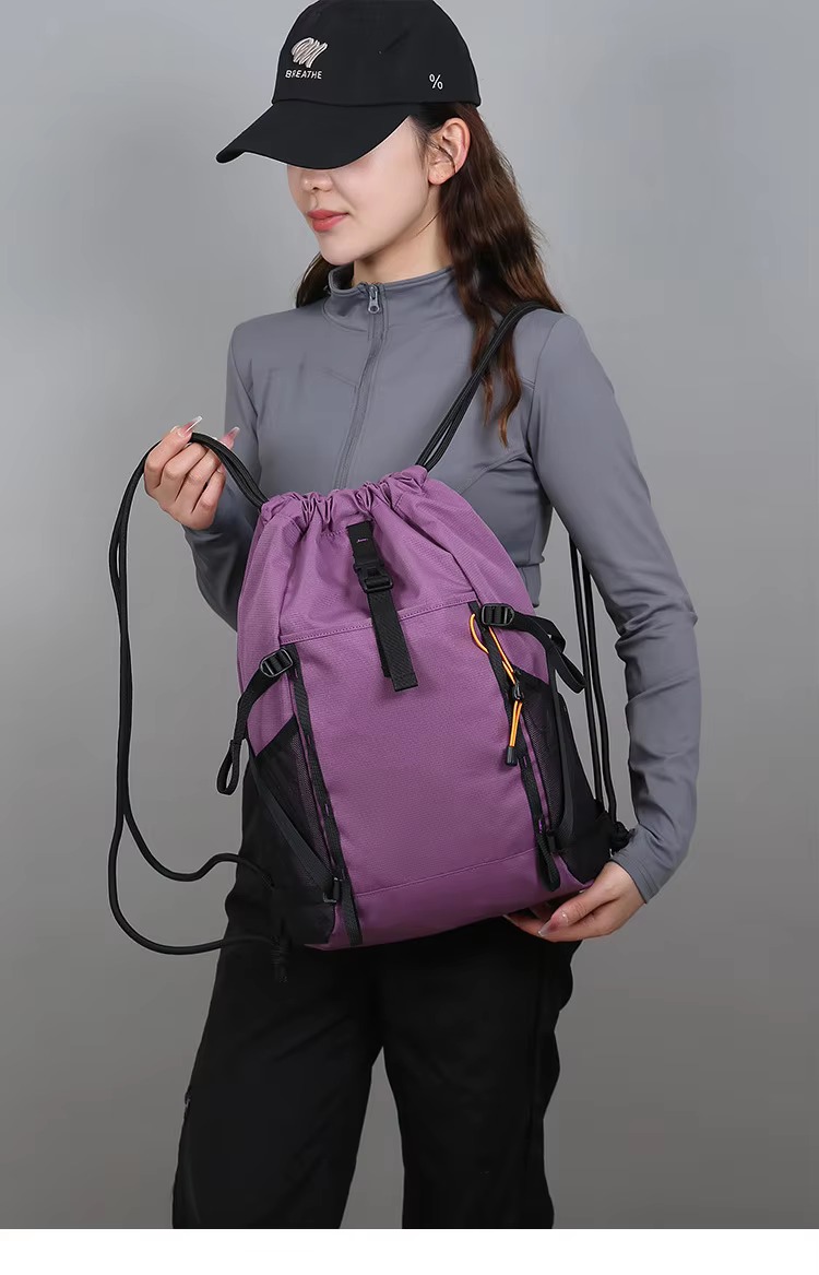 woman holding purple backpack