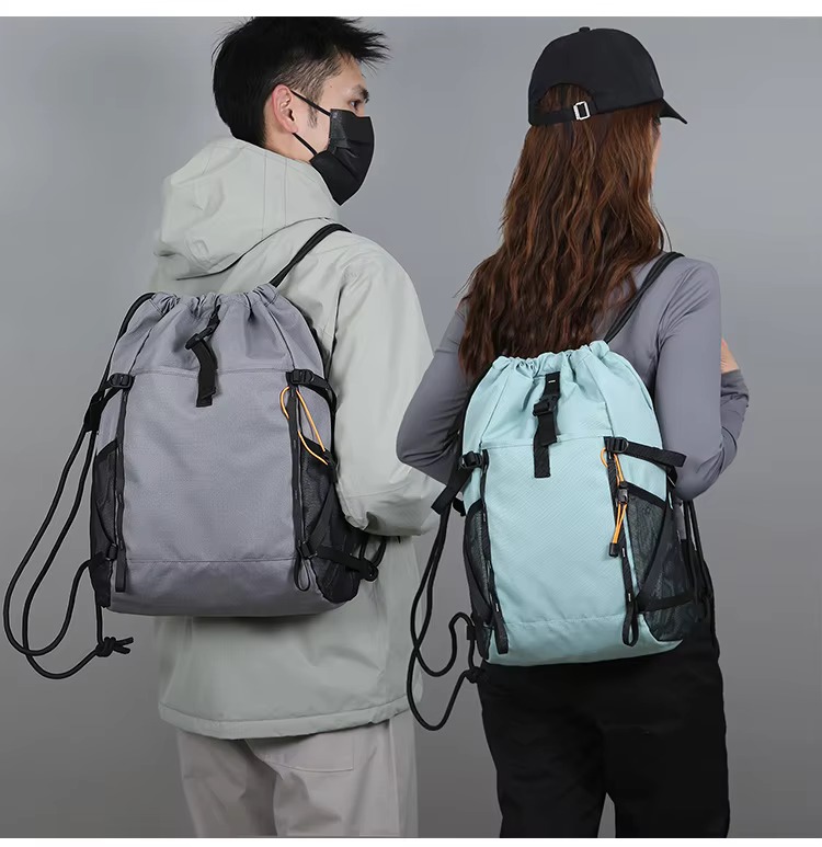 couple wearing gray and green backpacks
