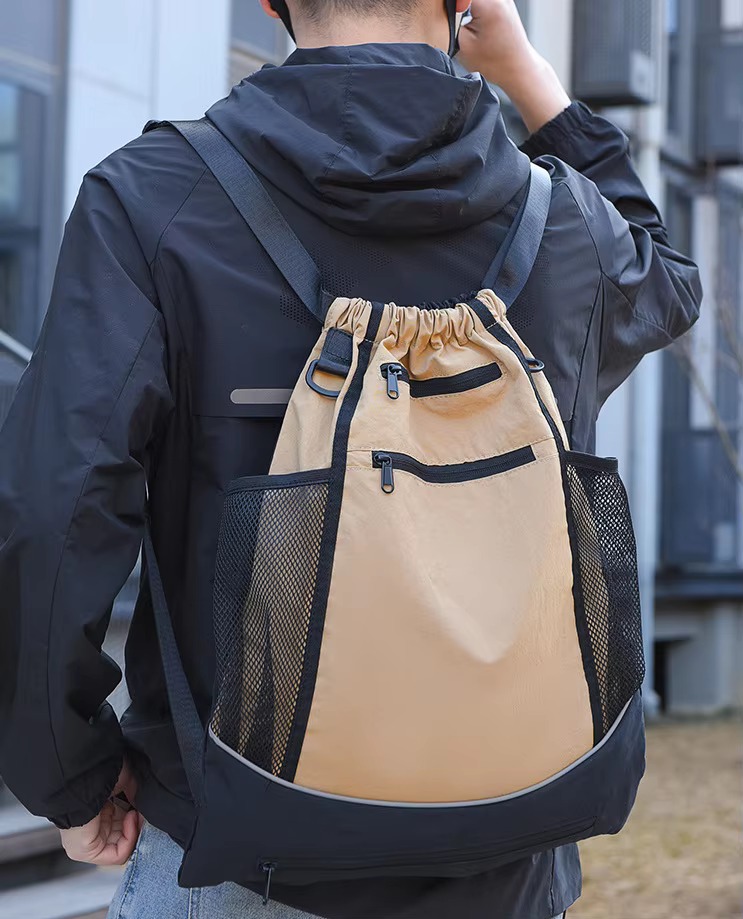 man wearing khaki backpack back view
