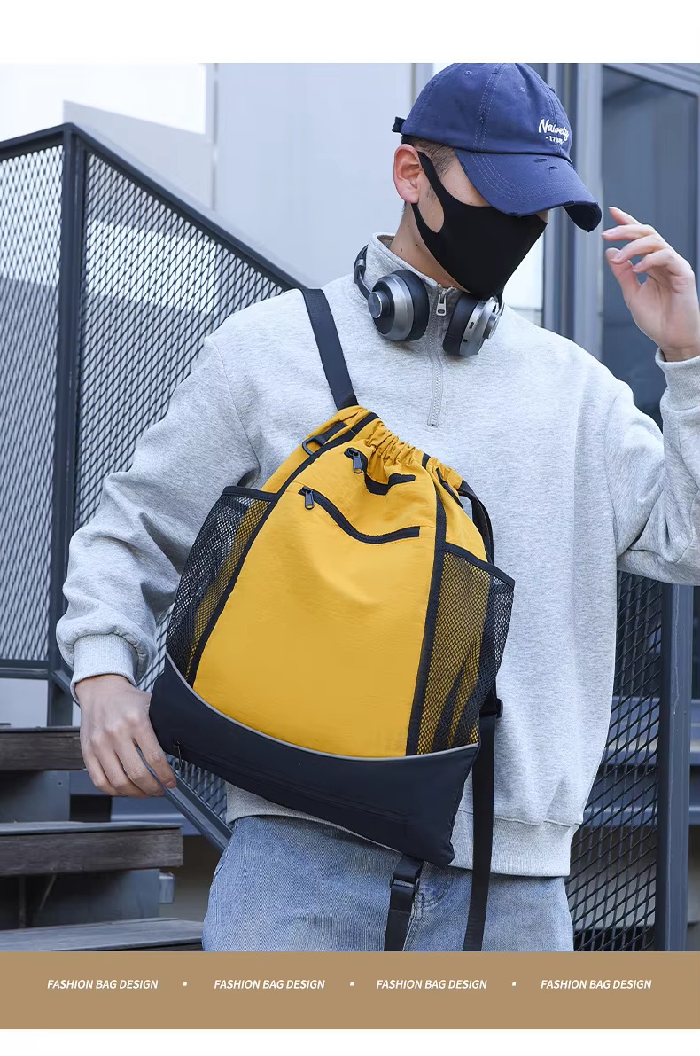 man carrying yellow backpack on one shoulder
