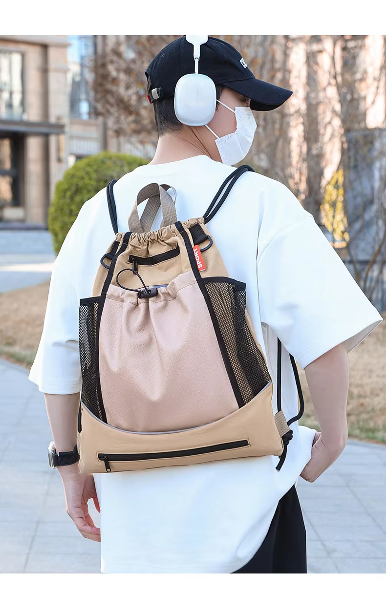 man wearing khaki backpack back view