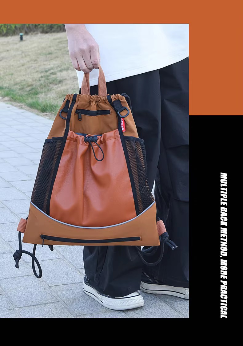 man carrying orange backpack by hand
