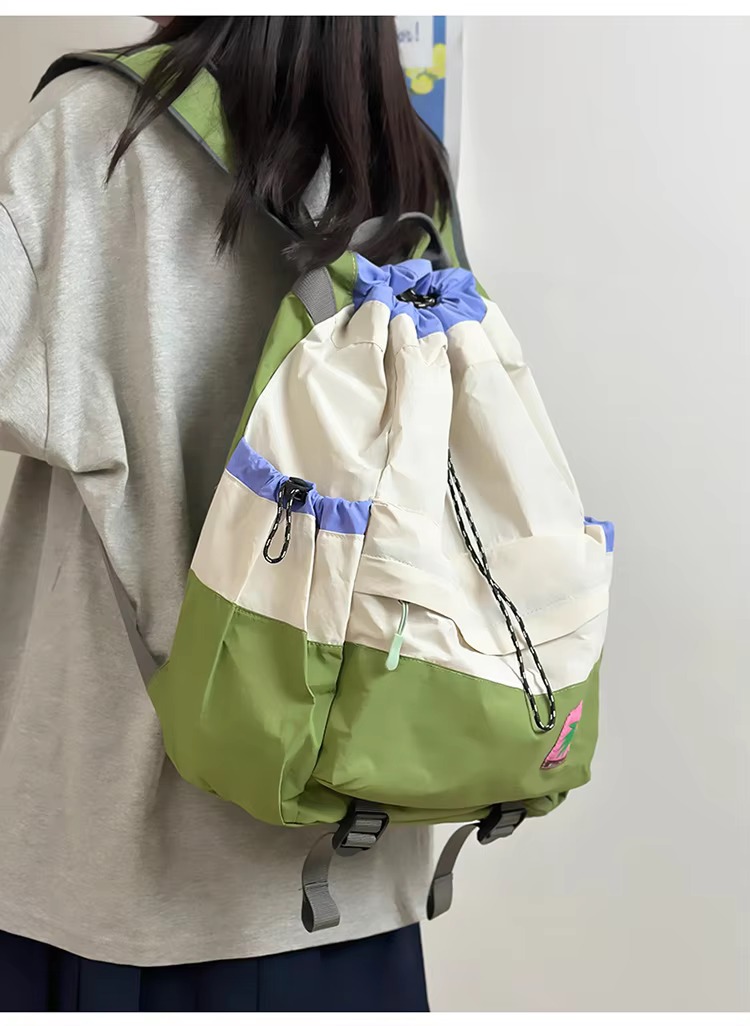 student wearing beige backpack back view