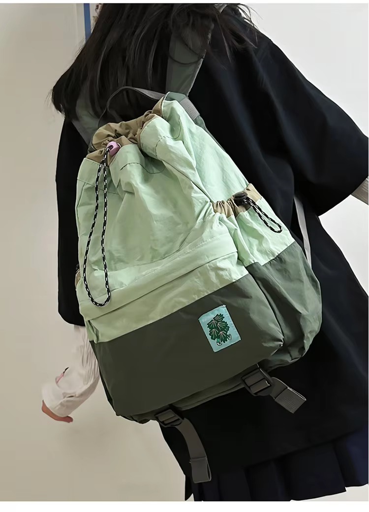 student wearing green backpack