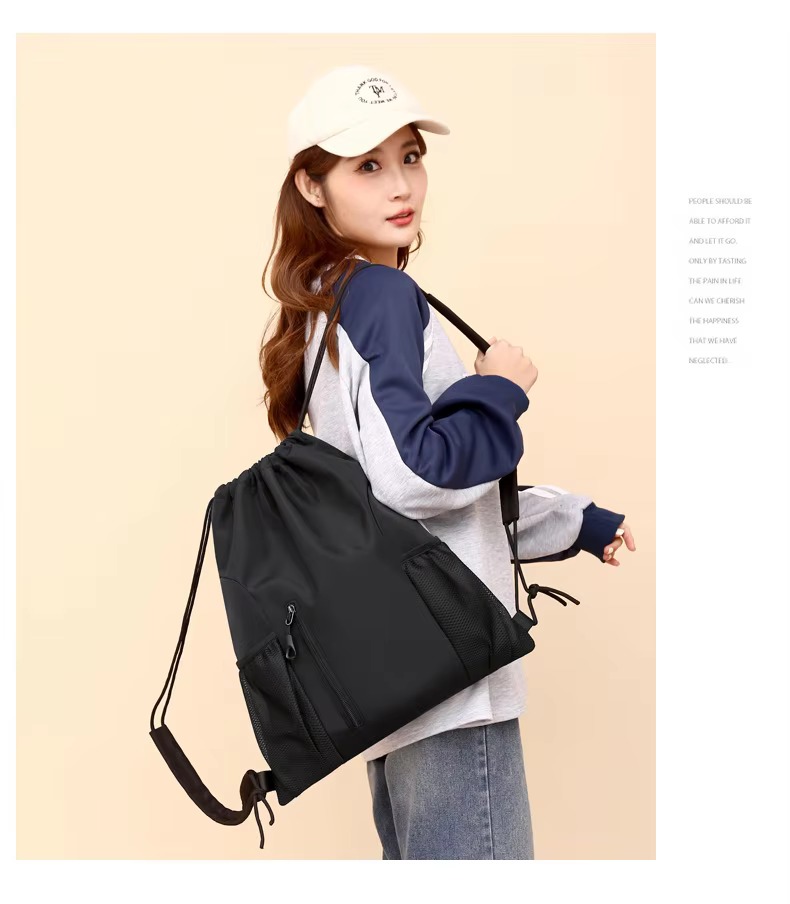 woman holding black backpack