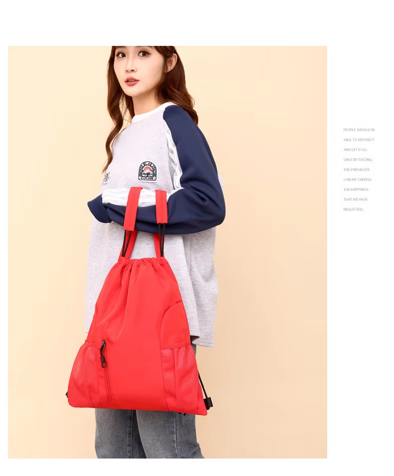 woman holding red backpack by straps