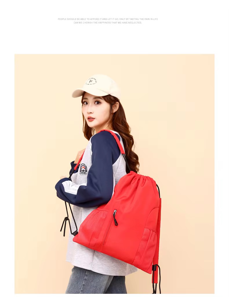woman carrying red backpack on shoulder