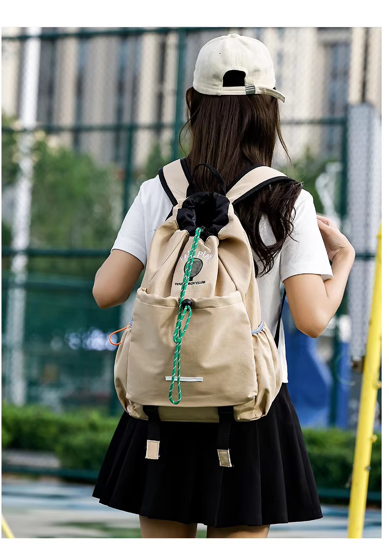 woman wearing khaki backpack