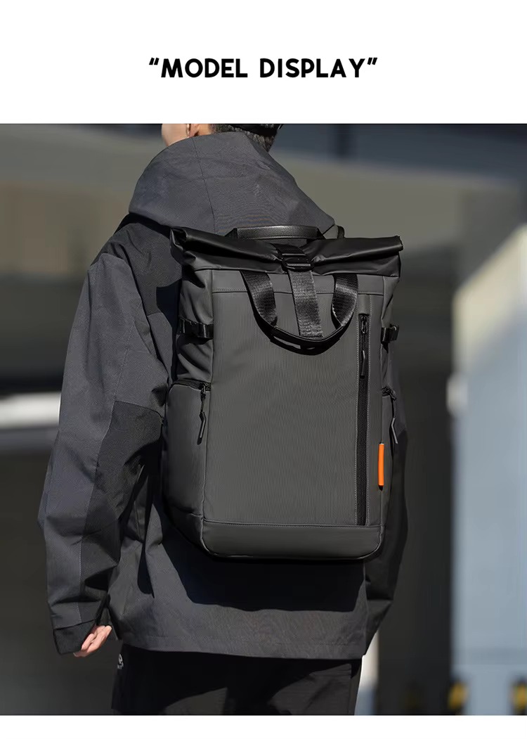 man wearing grey roll top backpack