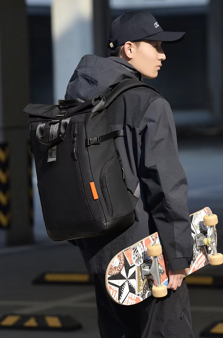 man with black backpack and skateboard