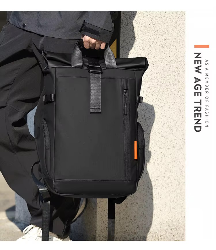 man carrying black backpack by handle