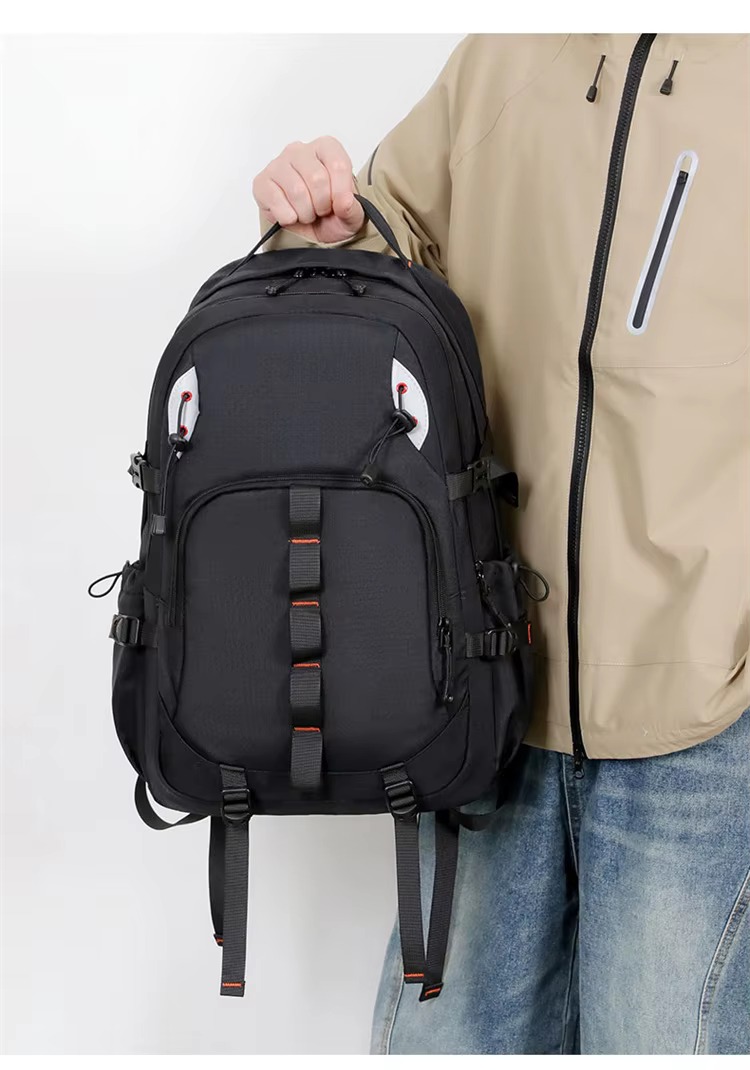 man holding black backpack