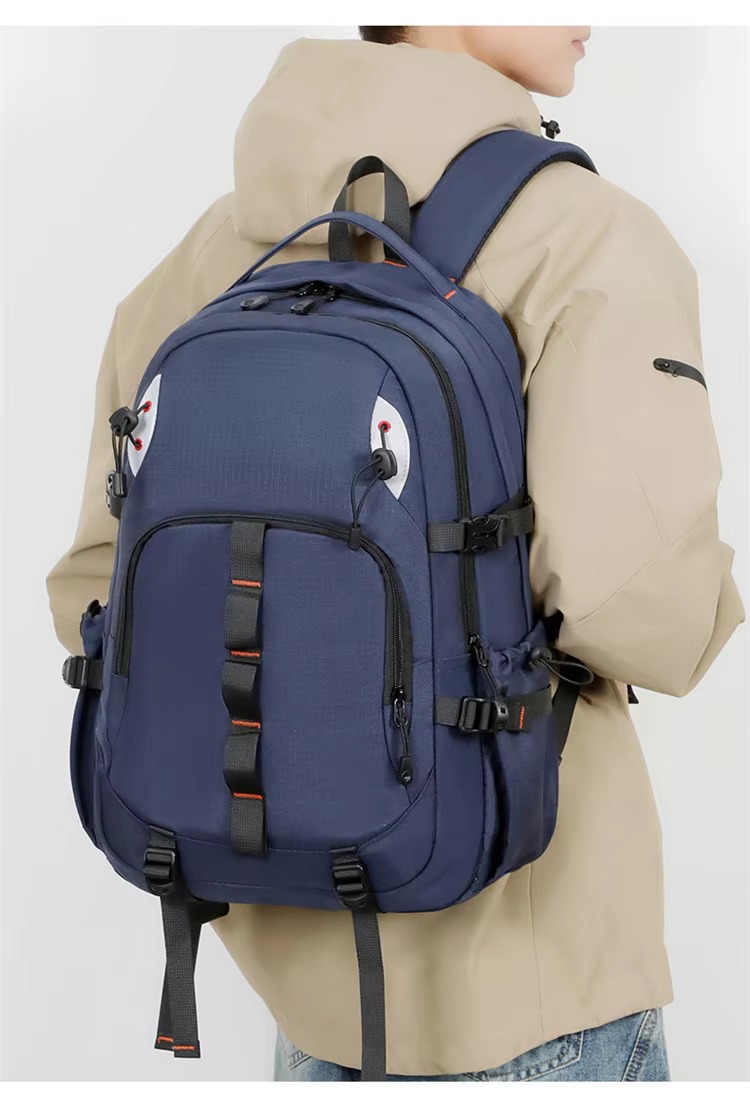 man wearing dark blue backpack side view