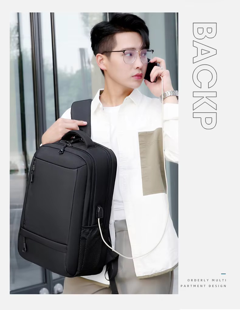 man carrying black backpack with charging cable