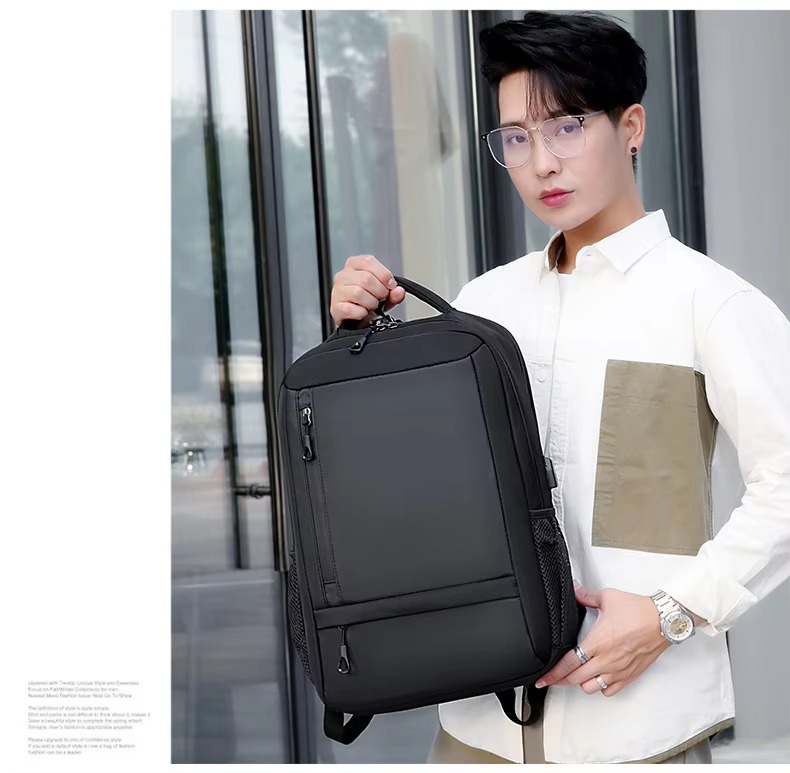 man holding black backpack
