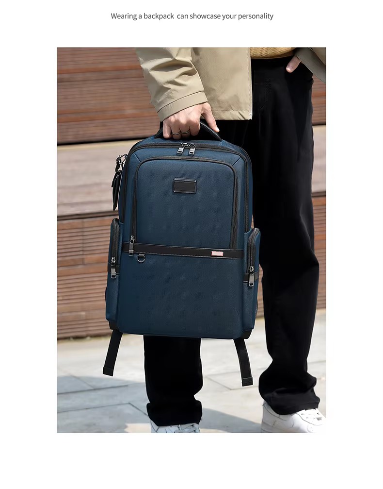 man holding blue backpack