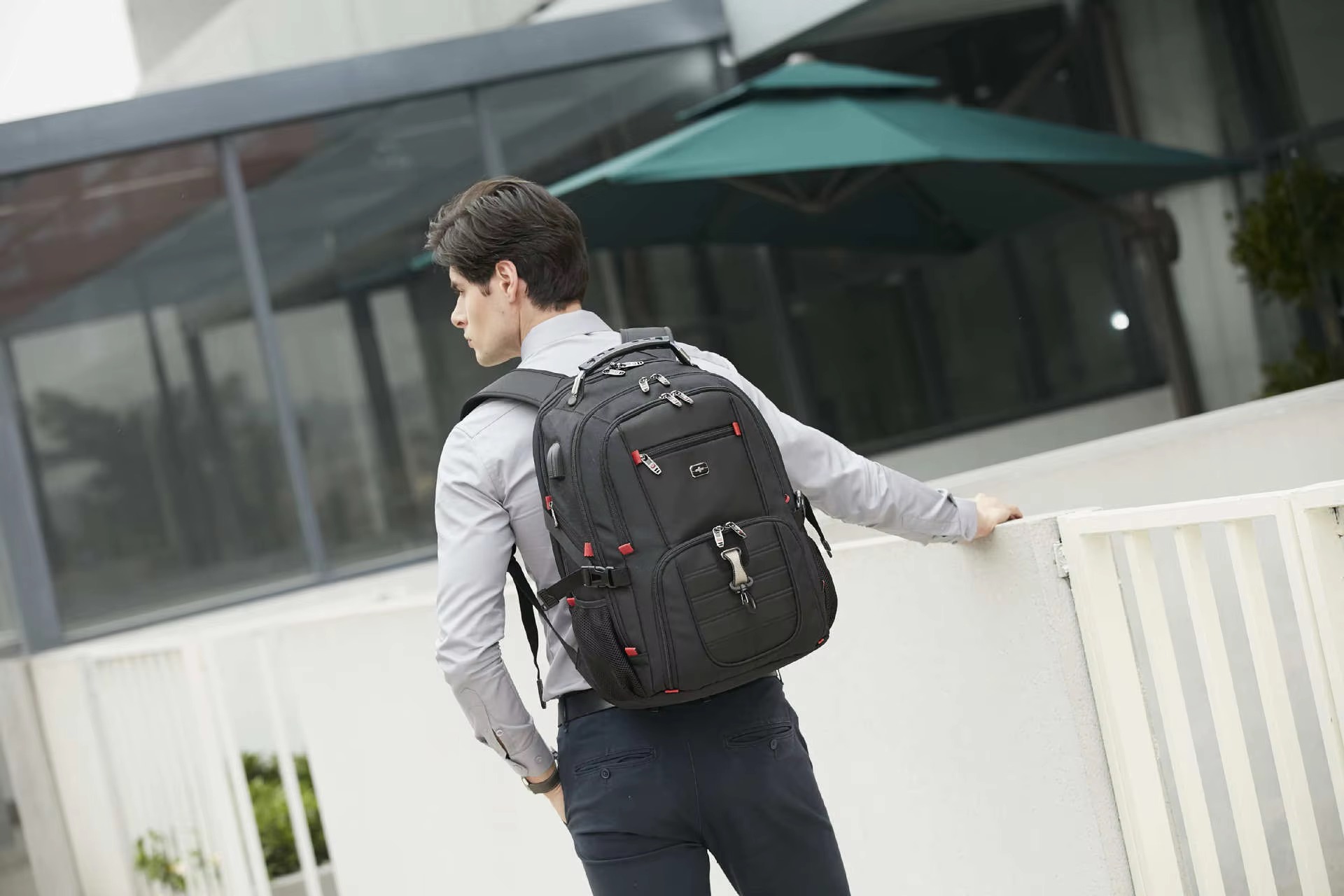man wearing black backpack back view