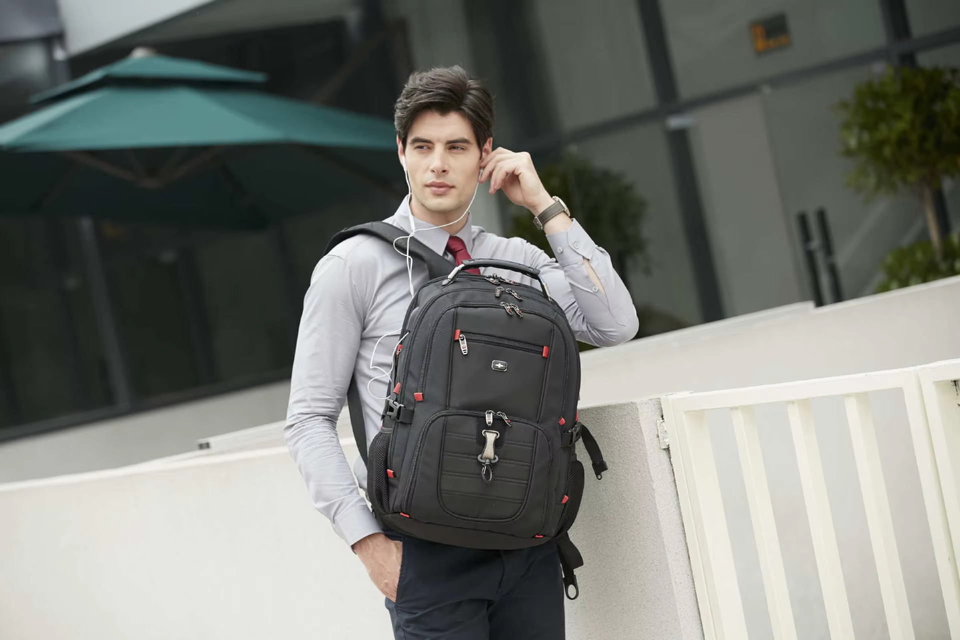man wearing backpack with earphones