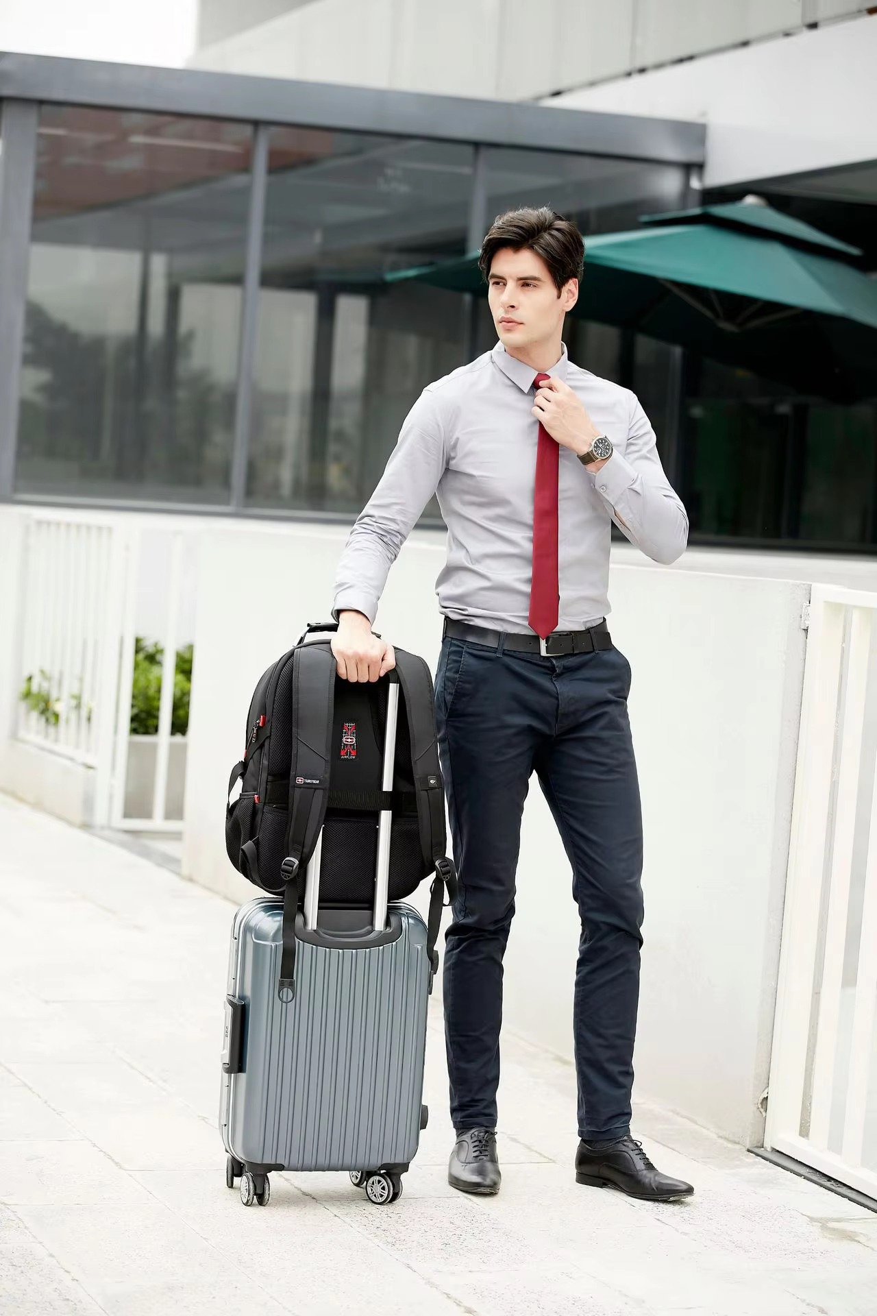 backpack attached to suitcase handle