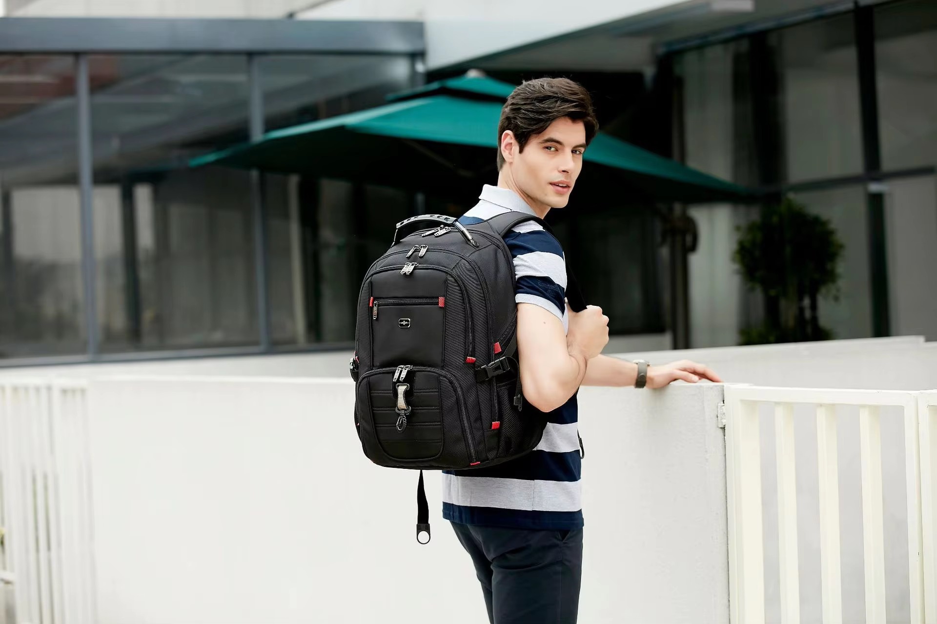 man in striped shirt wearing backpack