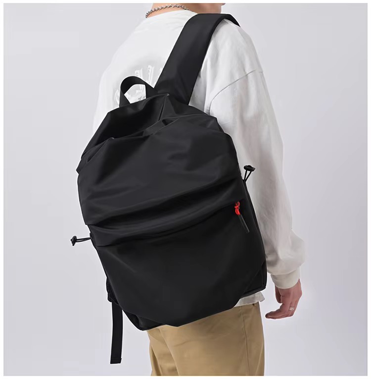 black backpack side view on model