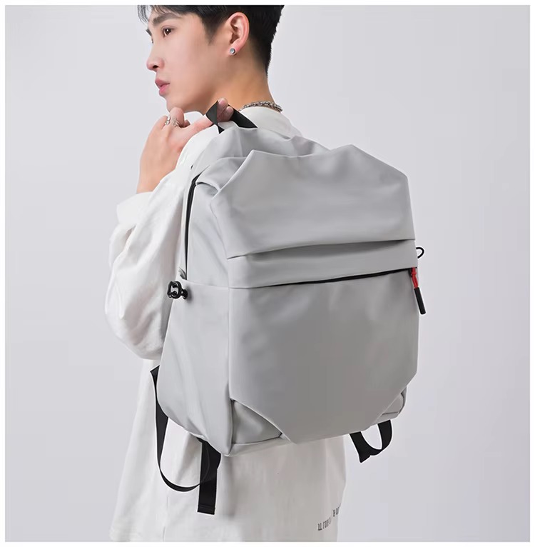 man wearing gray backpack