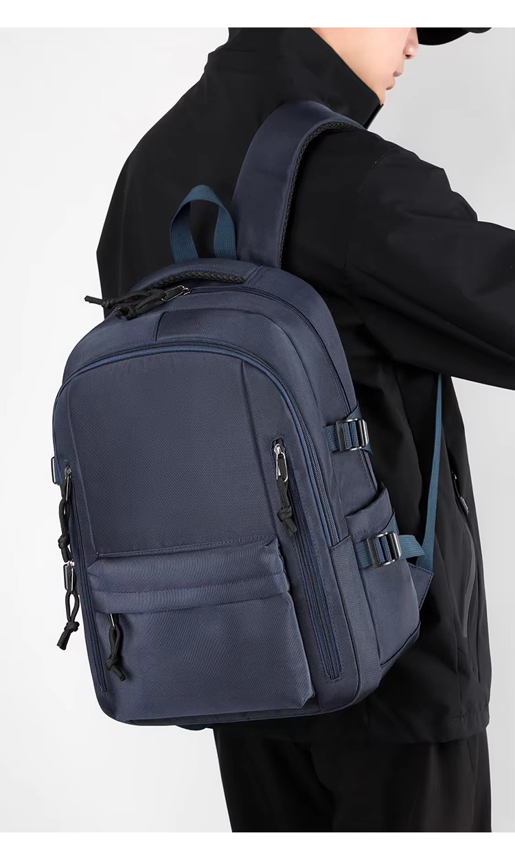 man wearing dark blue backpack side view