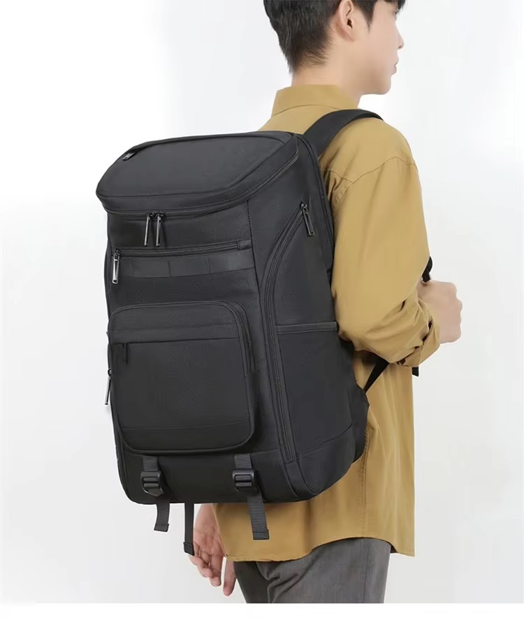man wearing black backpack back angle