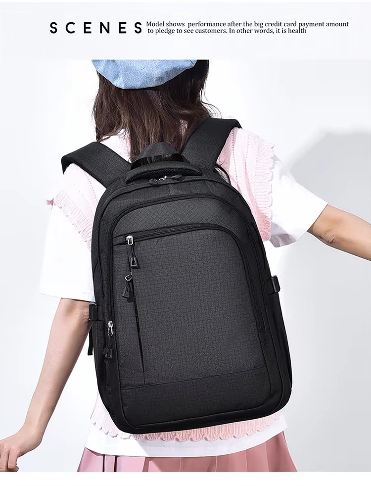 woman wearing black backpack back view