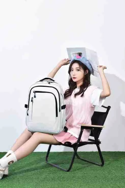 woman holding white backpack