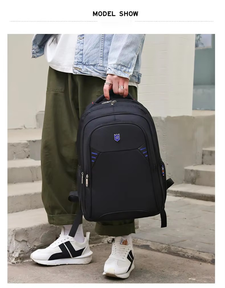 man carrying backpack by handle