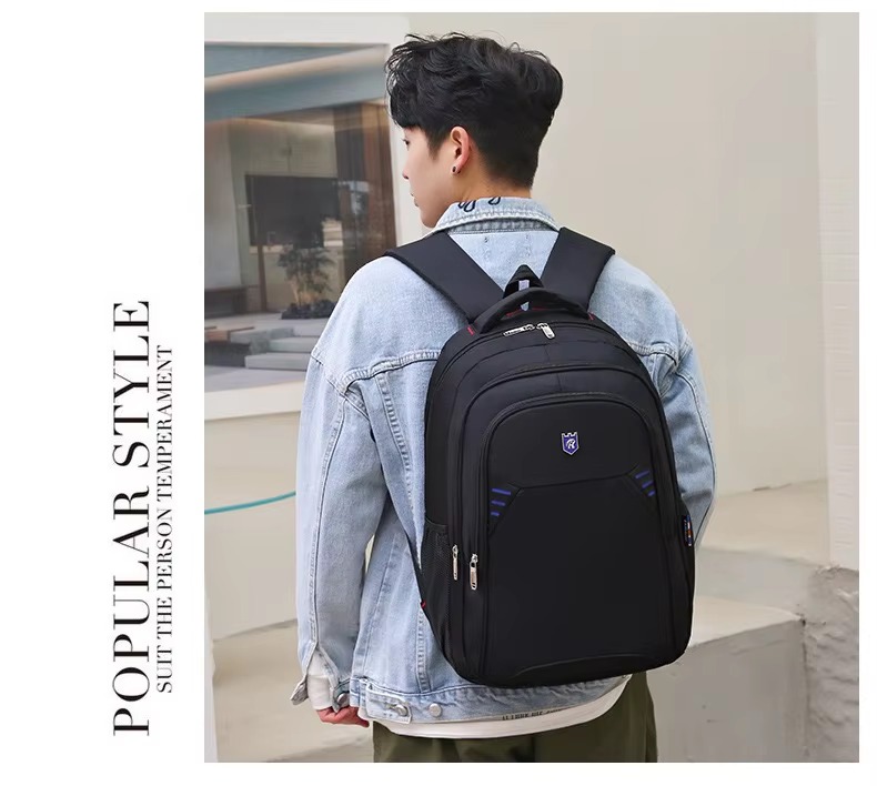 man wearing backpack back view by building