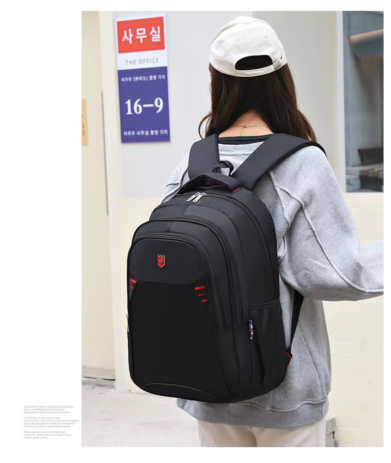 woman wearing red accent backpack back view