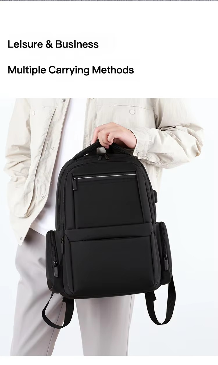 man carrying backpack by handle