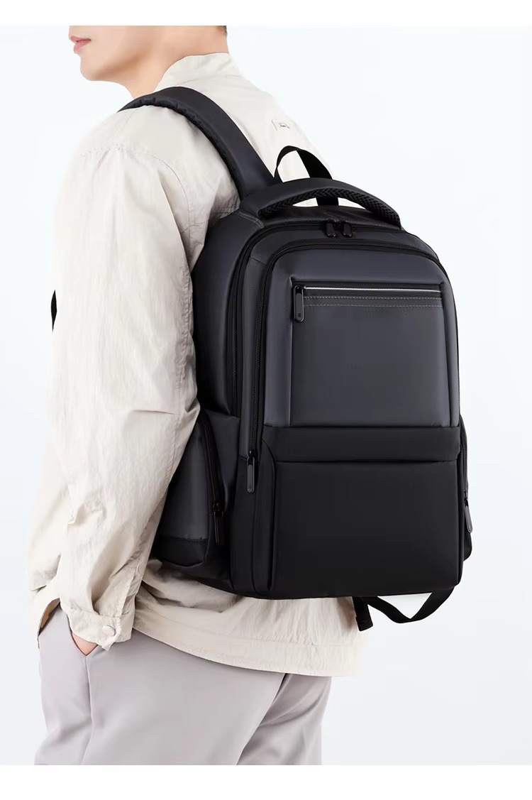 man wearing gray backpack side view