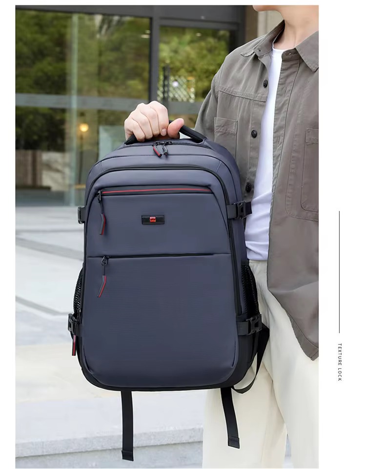 man holding blue backpack by handle