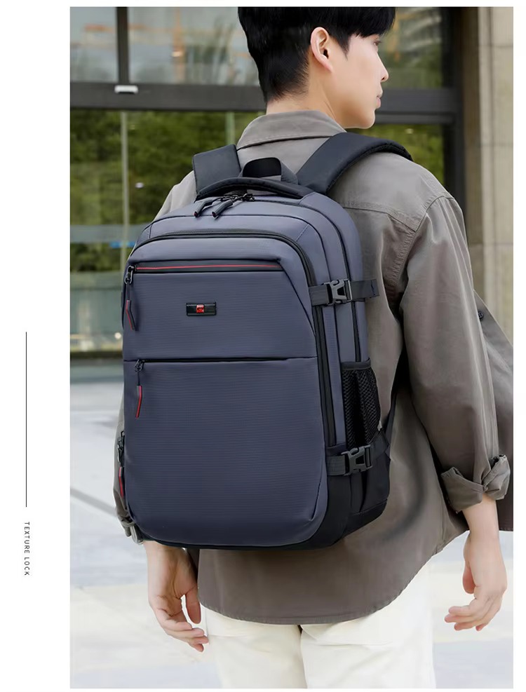 man wearing blue backpack back view