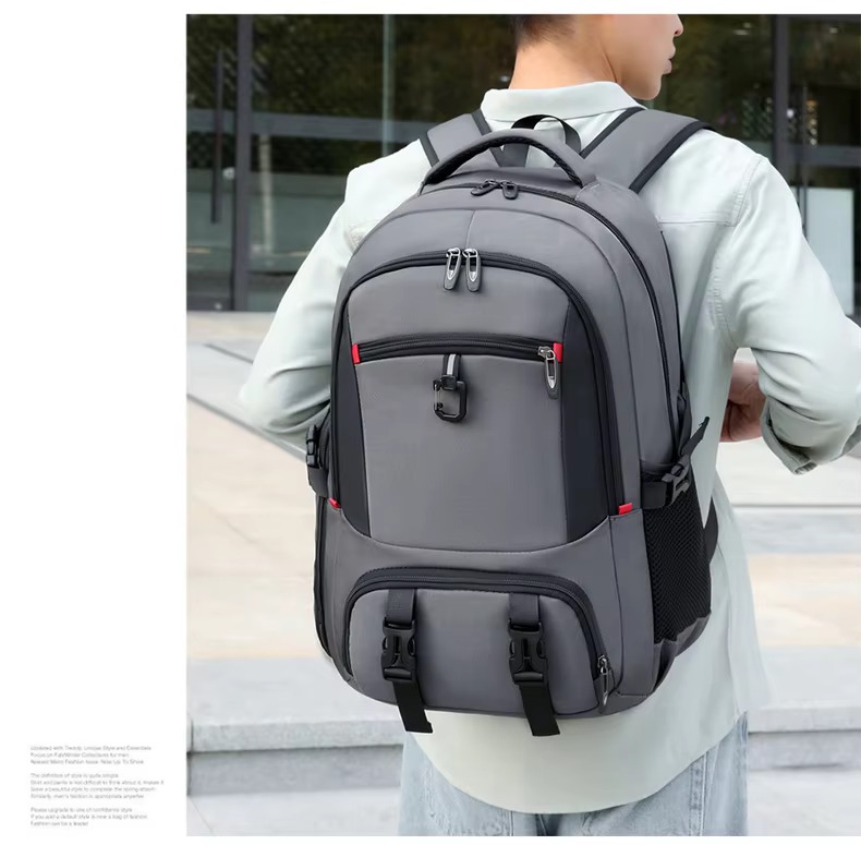 man wearing gray backpack back view